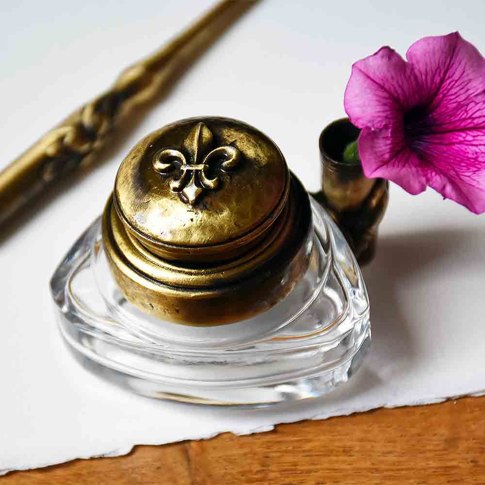 Triangular inkwell made of glass and pewter with a Lily Flower.